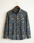 Floral patterned shirt on a hanger against a white background